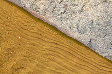 Stone and sand on the lakeside natural background.