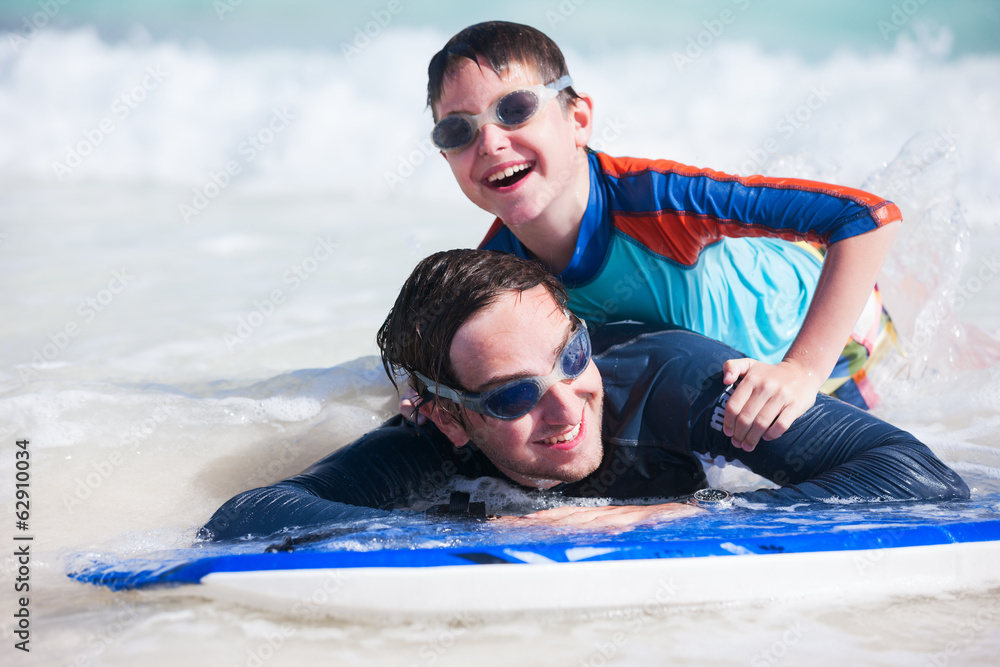 Poster father and son surfing