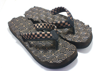 Pair of brown women's flip flop sandals isolated on white
