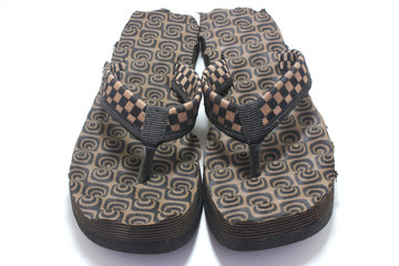 Pair of brown women's flip flop sandals isolated on white