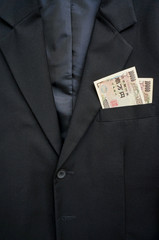 Money in the pocket of business suit