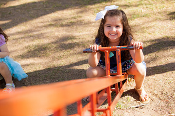 Little girl in a seesaw
