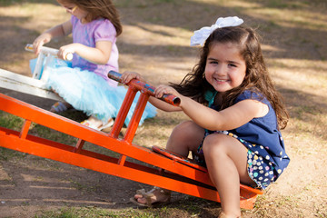 Cute little brunette in a seesaw