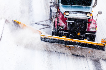Snowplow removing the Snow from the Highway during a Snowstorm
