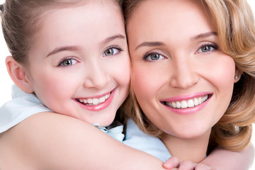 Closeup portrait of happy mother and young daughter
