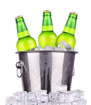 Beer bottles in ice bucket isolated