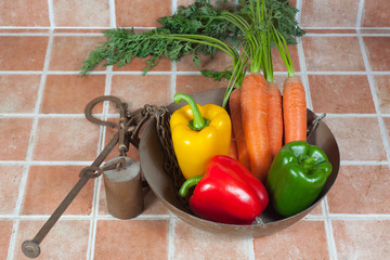 Yellow, red and green peppers and carrots in a romane scale