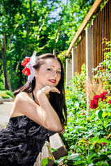 Beautiful woman on the bench in garden