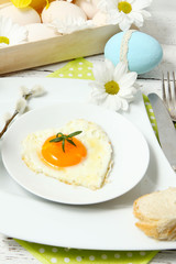 Easter table setting with flowers and eggs on old wooden table