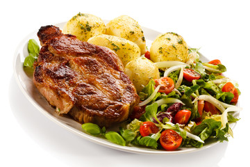 Grilled steak, boiled potatoes and vegetable salad
