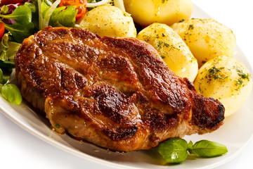 Grilled steak, boiled potatoes and vegetable salad