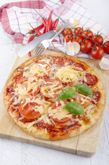 home made italian pizza with salami and tomato