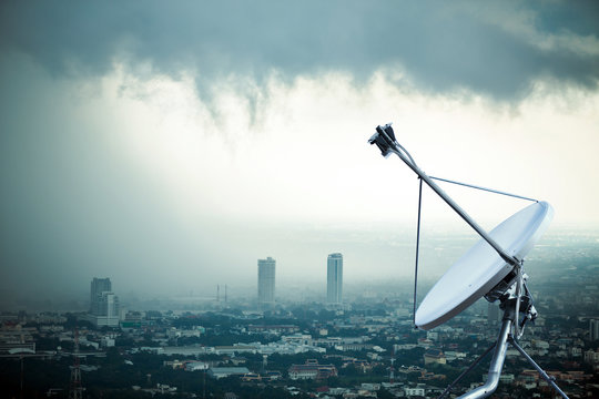 Antenna communication satellite dish with storm background