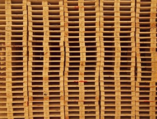 Texture of wooden euro pallets stocked in high column