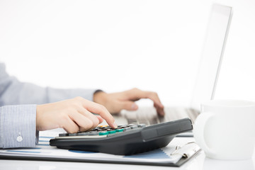 Business woman analyzing investment charts with laptop