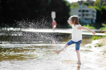Little girl having fun by a river