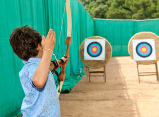 portrait of a child, archery, rear view