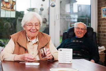 Elderly woman with dispenser
