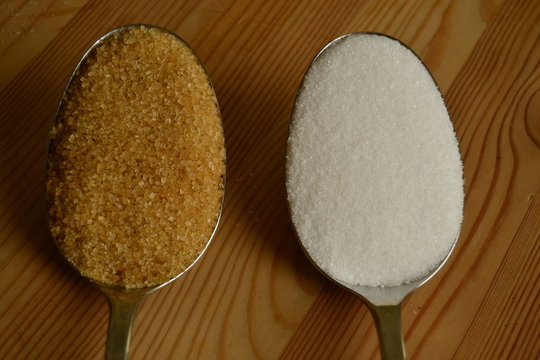 brown and white sugar in a tablespoon