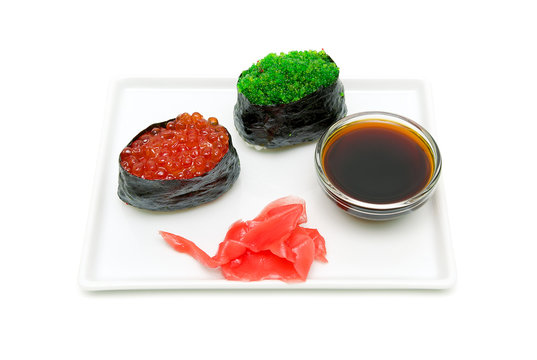 gunkan with caviar, soy sauce and pickled ginger on a plate on a