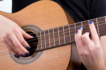 Fototapeta na wymiar woman fingers playing guitar