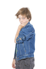 standing male teenager with one hand on a cheek, isolated on whi