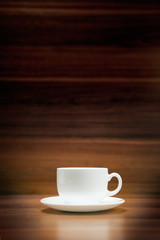 Cup of coffee on dark wood background