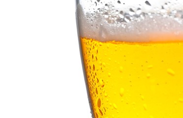 detail of glass of fresh beer with drops on white background