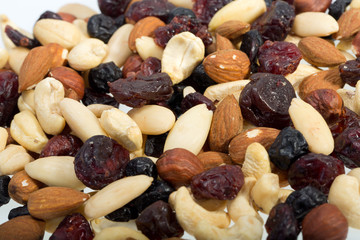 mixed nuts and dried fruits isolated on white background