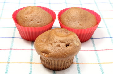 Fresh baked coffee muffins on colorful cloth