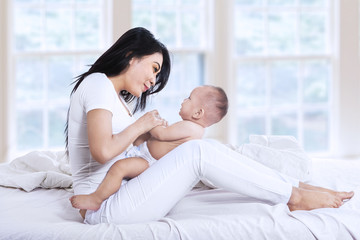 Attractive family playing in the bedroom