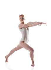 Skinny redhead gymnast posing in white leotard