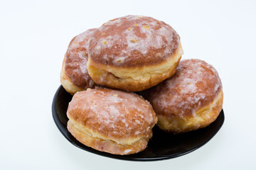 whole donuts on the black porcelain plate