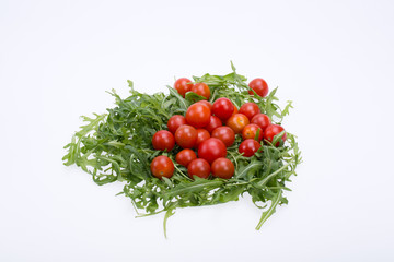 Heap of ruccola leaves and cherry tomatoes