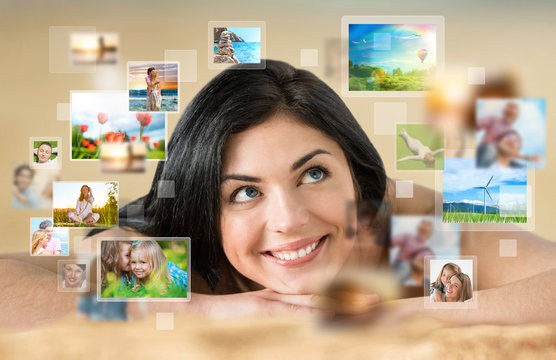 Woman laying on beach with lots of pictures around her