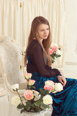 girl in dress near the screen with flowers