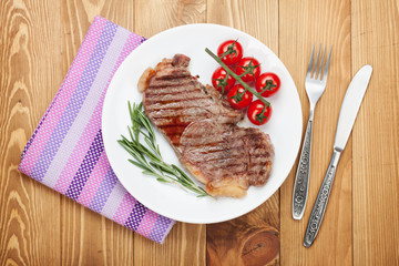 Sirloin steak with rosemary and cherry tomatoes on a plate