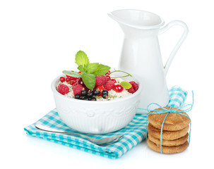Fresh corn flakes with berries and milk jug