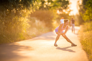 Young woman running outdoors on a lovely sunny summer evening