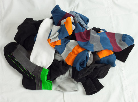 Pile Of Unsorted Socks On White