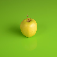 Y/ellow apple on green background