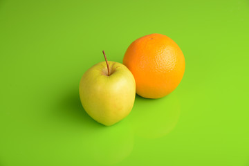 Yellow Apple with Orange on green background