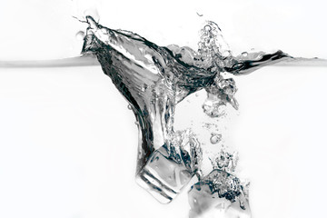 Ice cubes splashing into water isolated on white