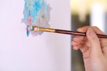 Artist paints picture close-up