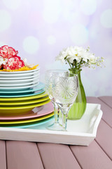 Stack of colorful ceramic dishes and flowers,