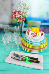 Stack of colorful ceramic dishes and flowers,