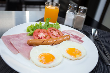 American breakfast with eggs ham bacon and sausage