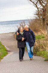 happy mature couple relaxing baltic sea dunes