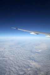 Fototapeta na wymiar Wing of airplane from window