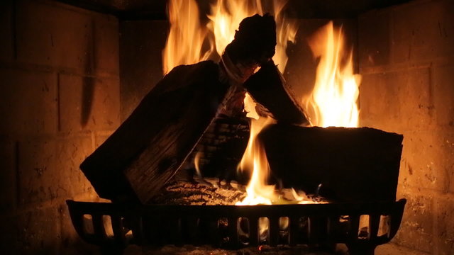 Burning wood in stone fireplace